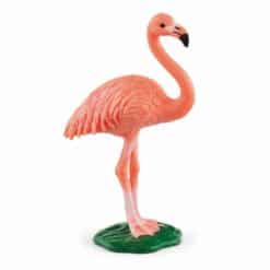 vaaleanpunainen flamingo, joka seisoo pienellä vihreällä jalustalla